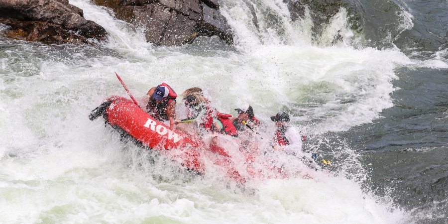 A ref raft crashing through a large wave in a rapid on the Clark Fork. 
